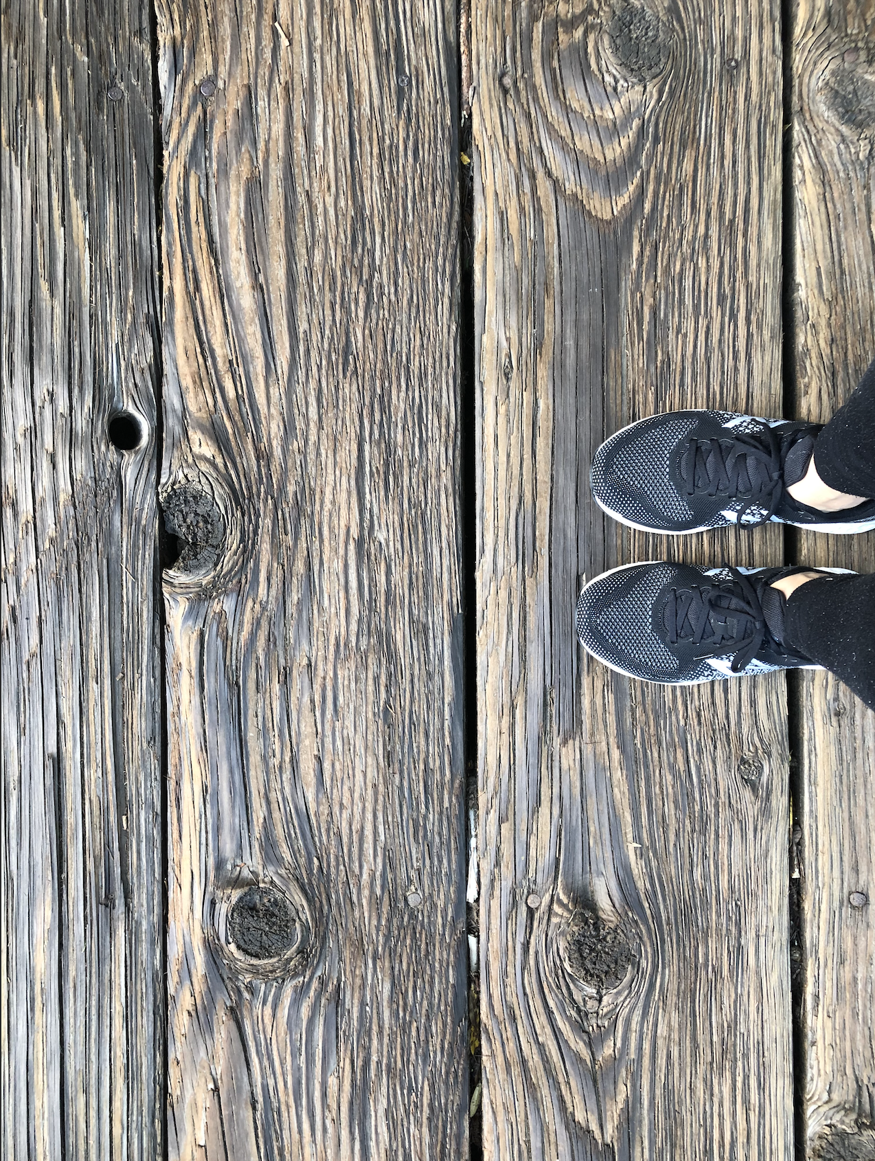 The June edition of ACT on 2021; a pair of running shoes on a wooden bridge, as a way of remembering to be human in new interactions. 