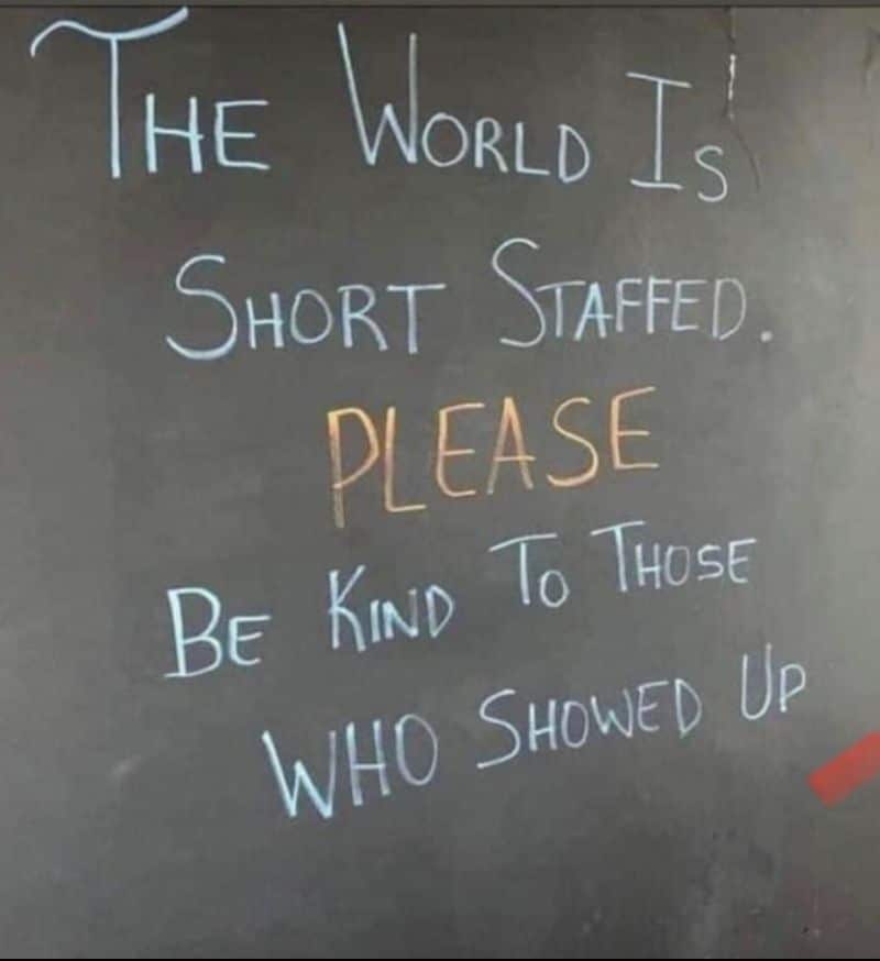 A chalkboard sign saying "the world is short staffed. PLEASE be kind to those who showed up.